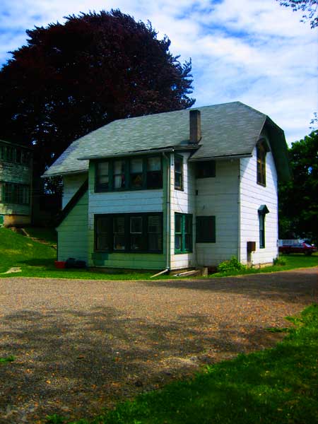  back view of former carriage house in 2010 with asbestos siding