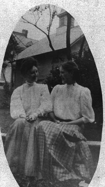 Evans' sisters in yard of 7 Athens street. Carriage house at 9 Athens street in the background, with cupola