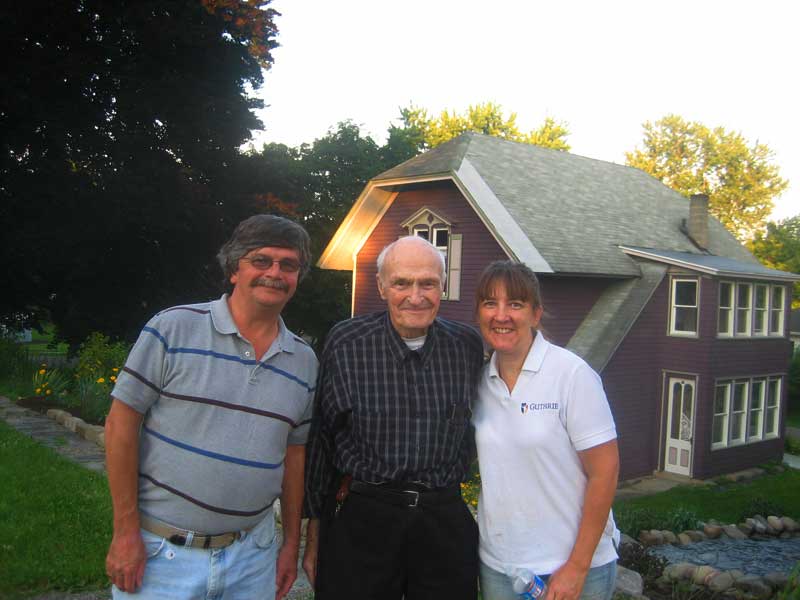  Mr. Kraus with his son, Bill, visiting, Amy in picture also with former carriage house in the background